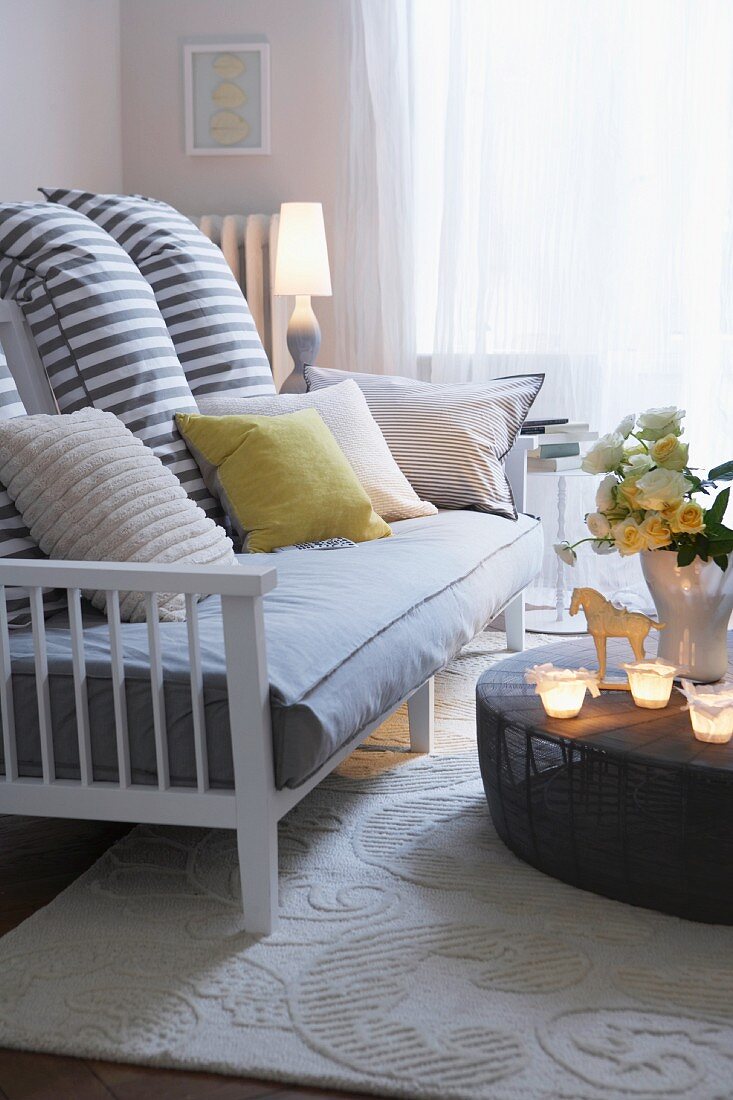 Striped scatter cushions on sofa with wooden frame