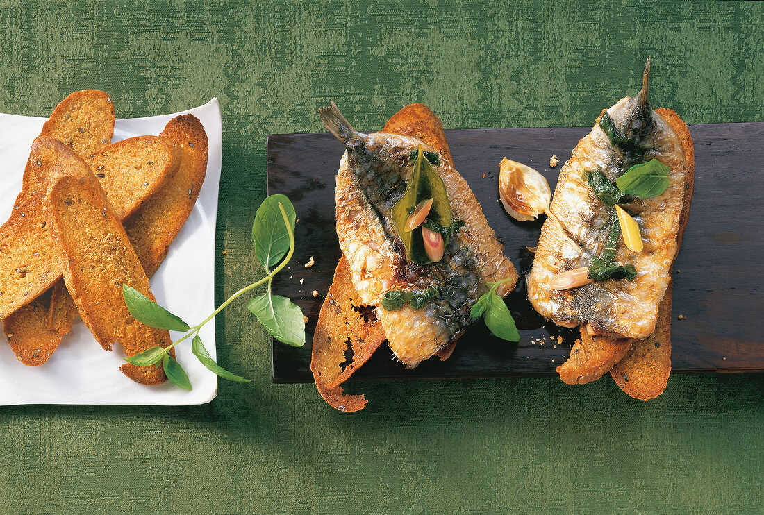 Coffee sardines with mint on plate, overhead view