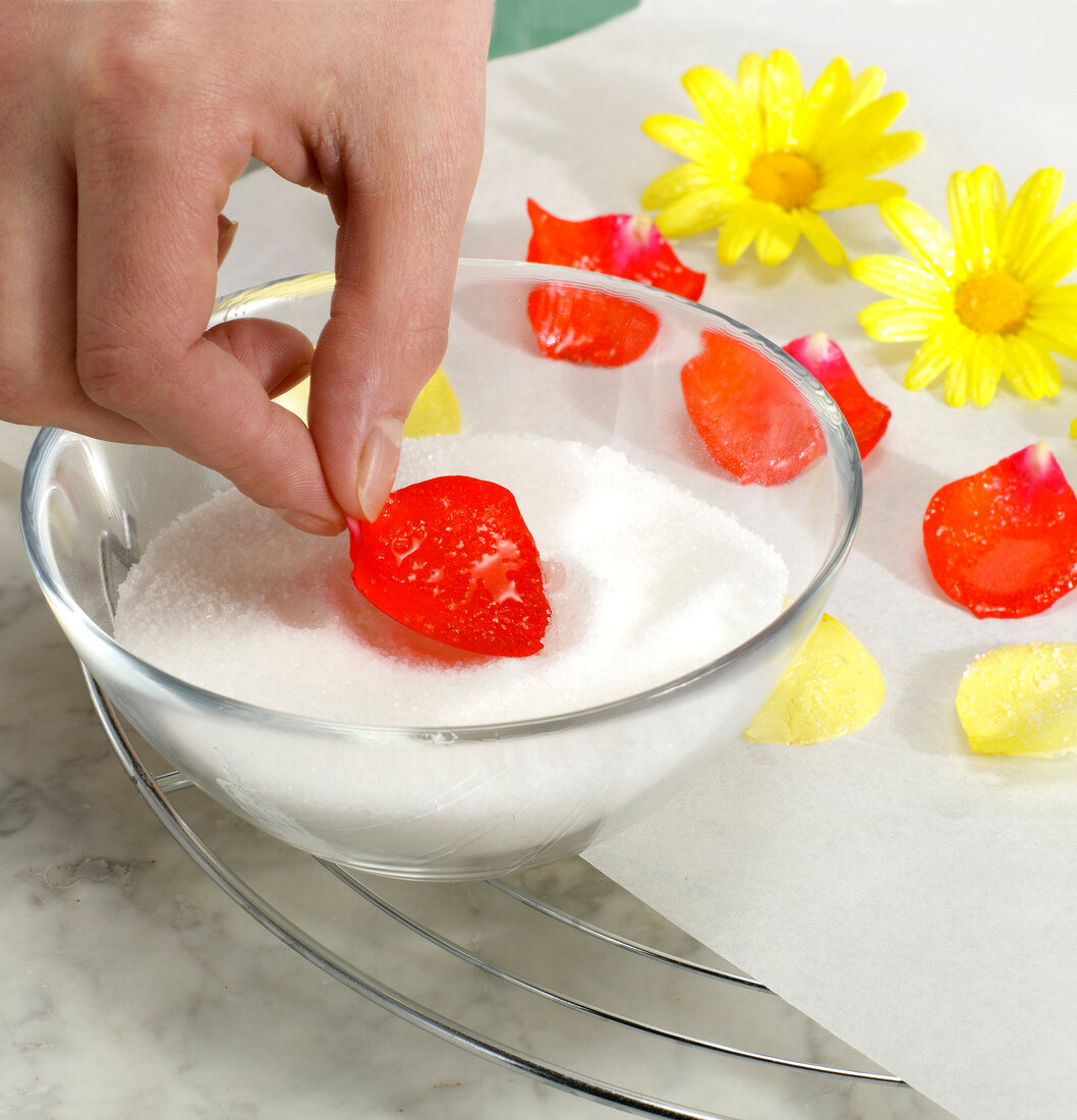 Flowers being put in bowl of sugar, step 2