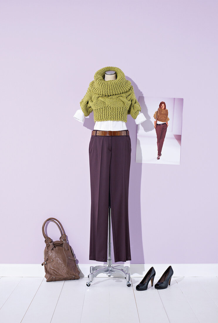 Short green sweater withy brown pants on mannequin