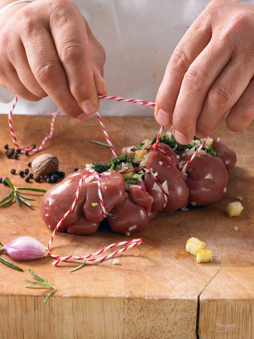 Kidneys being tied with twine