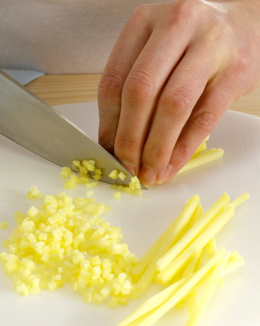 Ginger being cut into cubes with knife, step 6