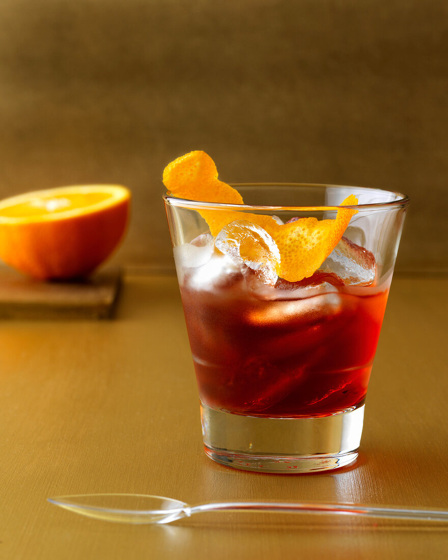 Classic negroni with campari, orange and ice cubes in glass