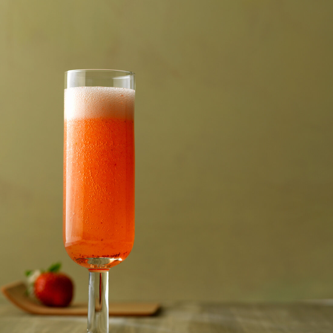Bellini rossini with prosecco and strawberries in champagne glass
