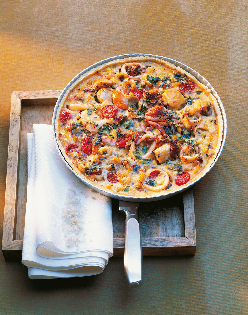 Seafood tart on wooden board