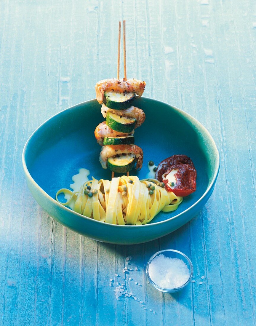 A prawn skewer with courgettes and saffron noodles