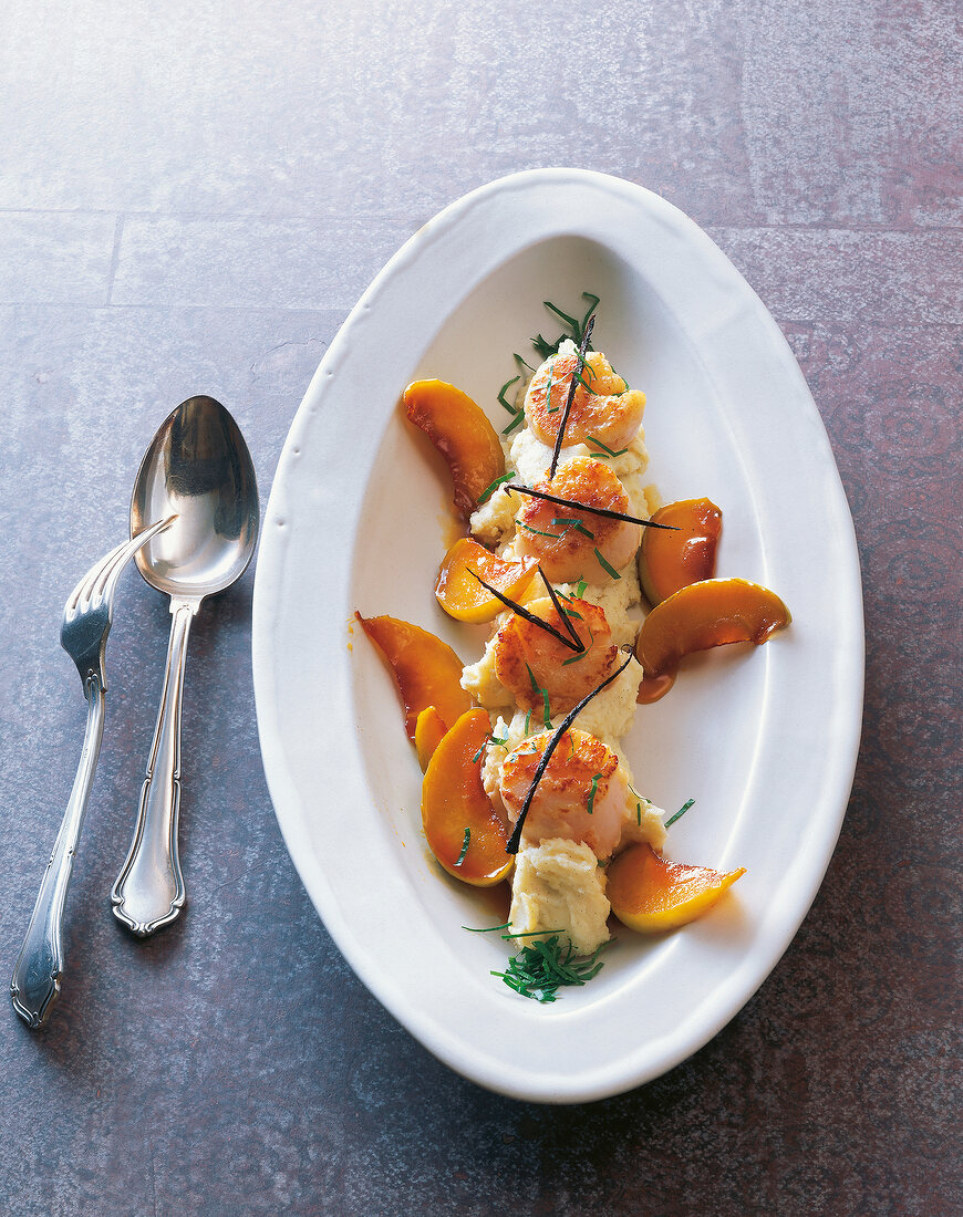 Scallops with vanilla puree and caramel apples on plate