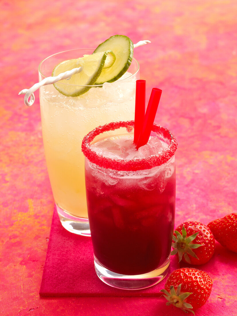 Cucumber juice and strawberry juice with sugar rim on glass