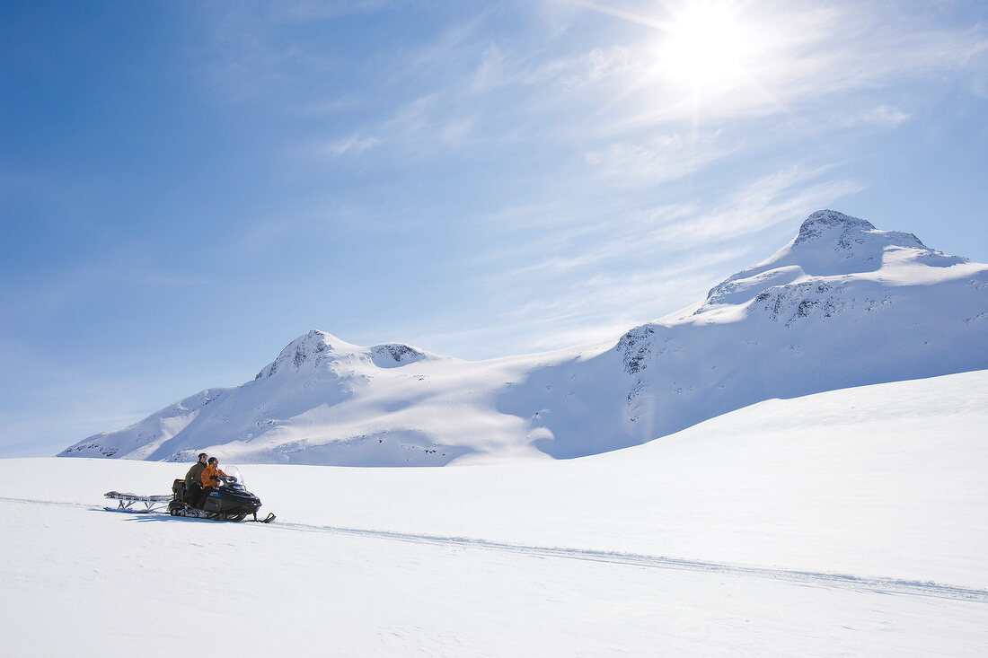 People Snowmobiling in Norway