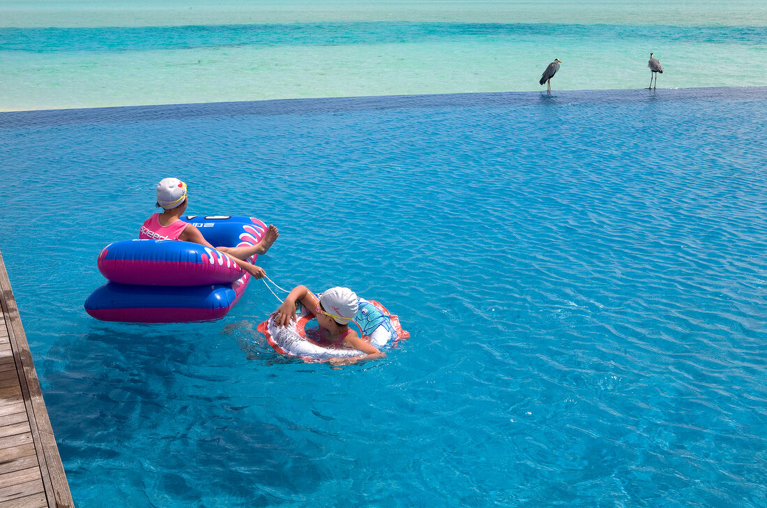 Two children at pool in Dhigufinolhu Island, Maldives