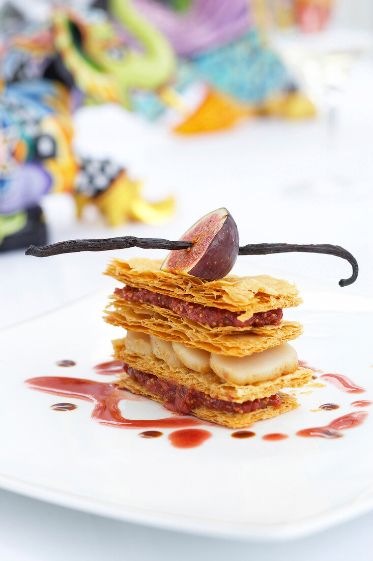Mille-feuille of scallops and figs on plate