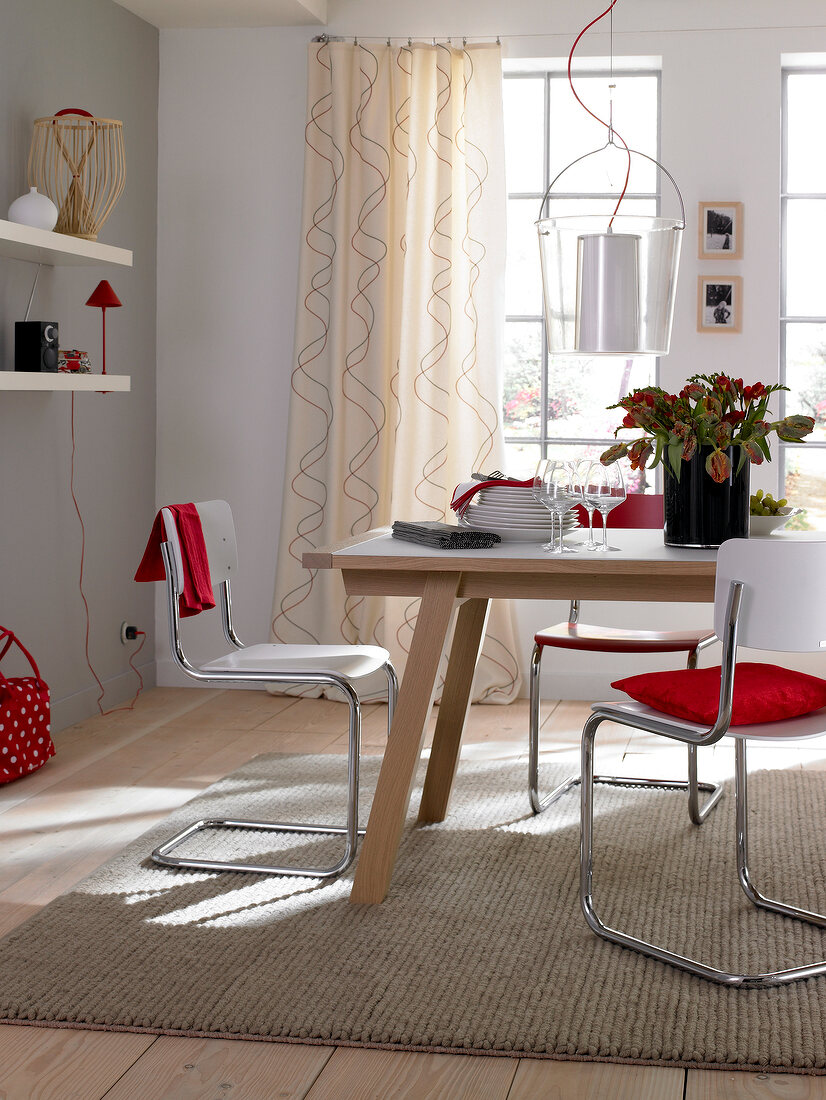 Dining table with chairs in front of window