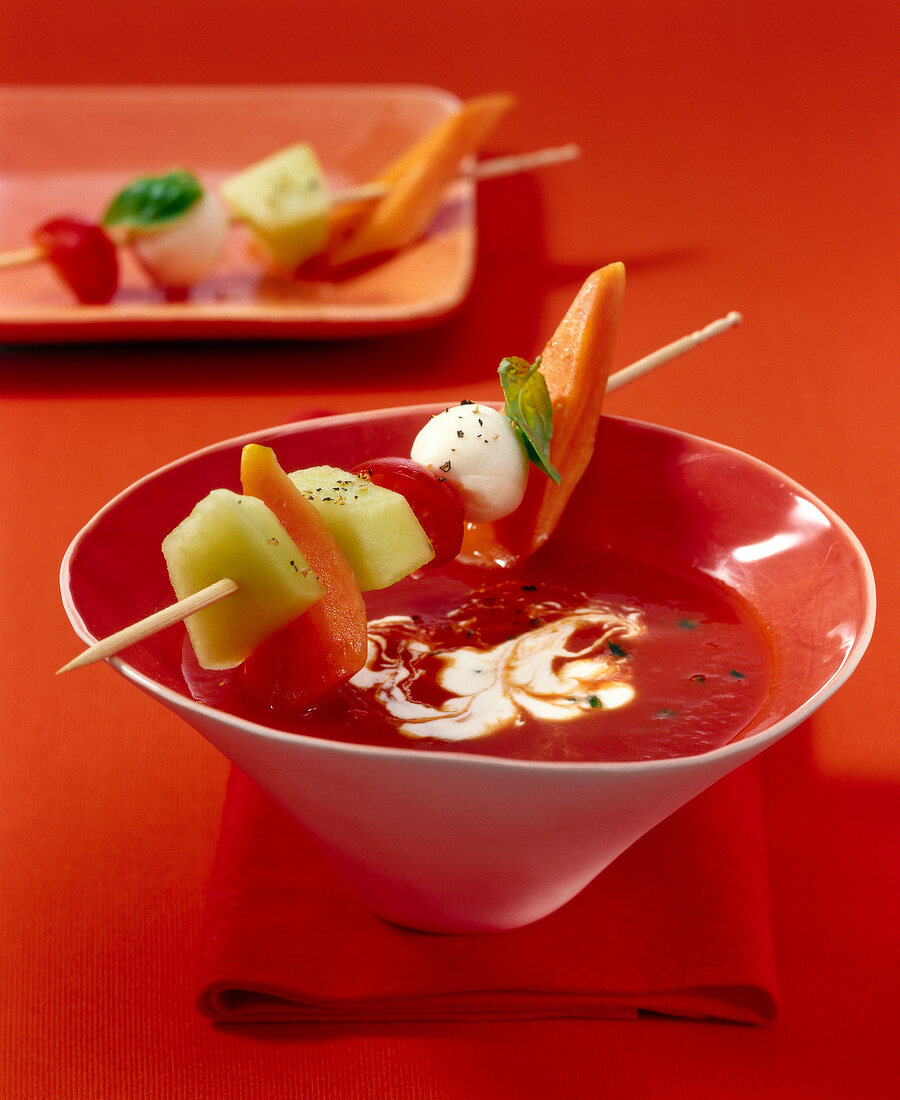 Close-up of Spicy tomato soup with cantaloupe, papaya and mozzarella in bowl