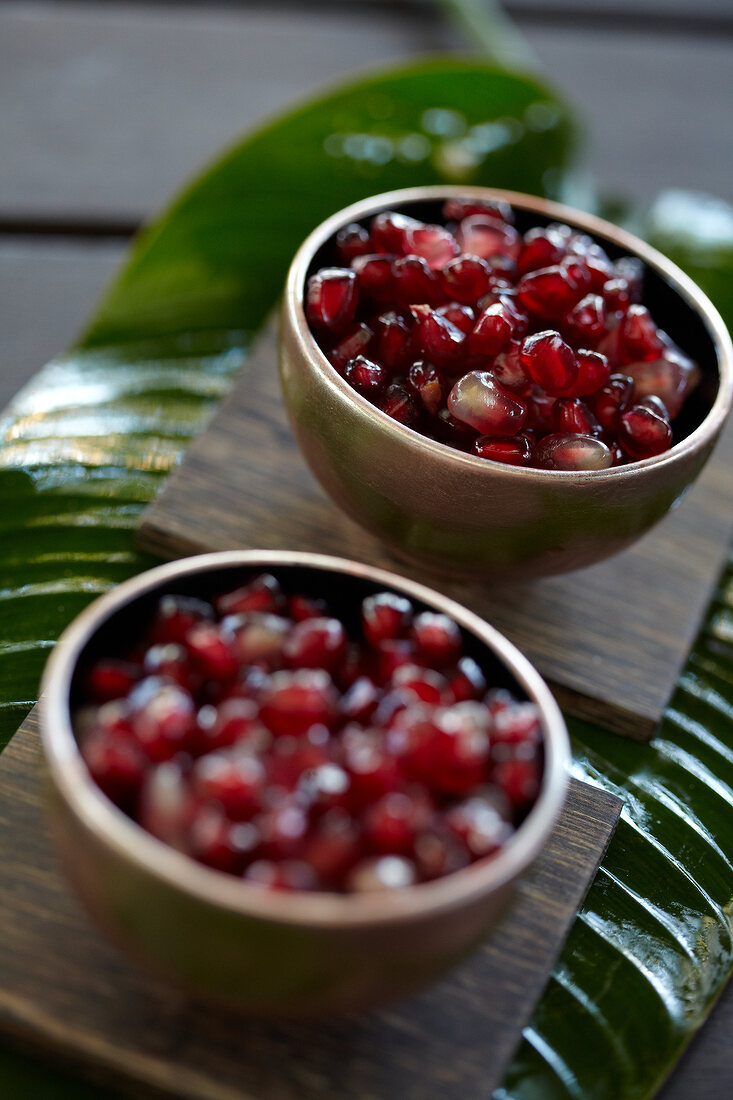Close-up of pomegranate seeds in two cups