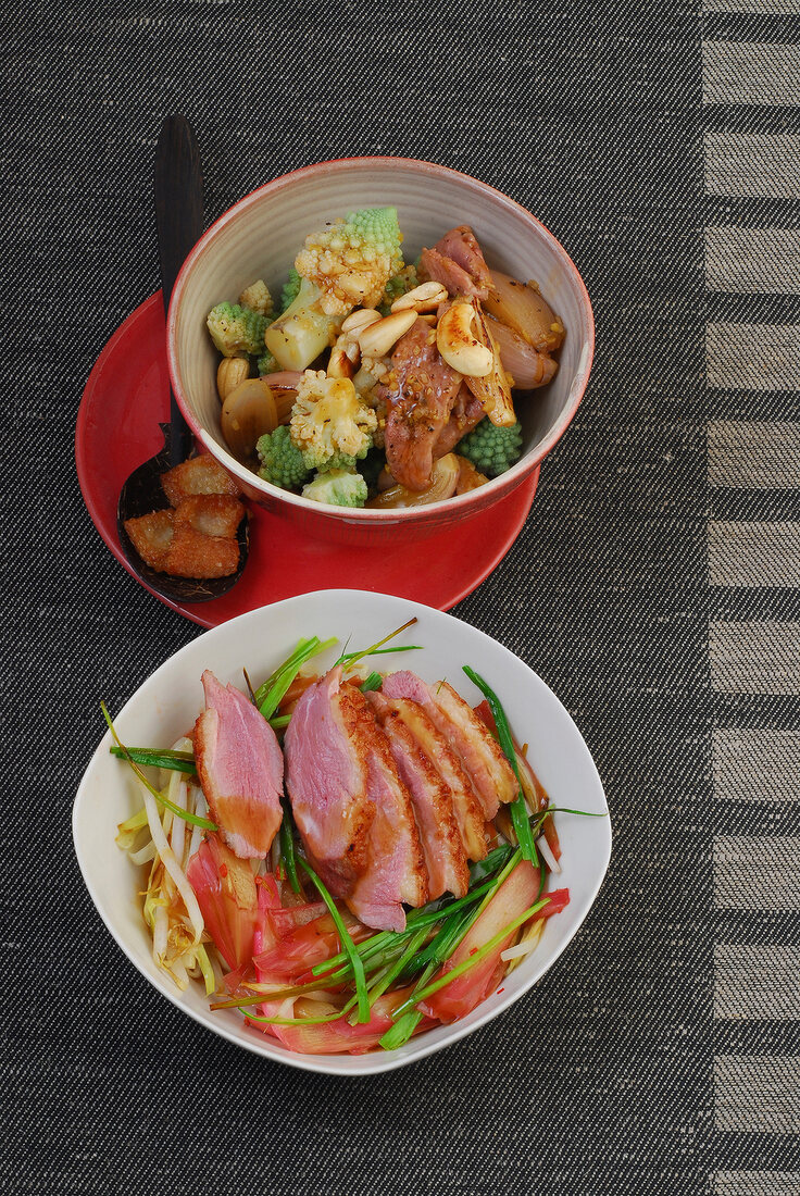 Duck with romanesco broccoli and duck with leeks in bowls