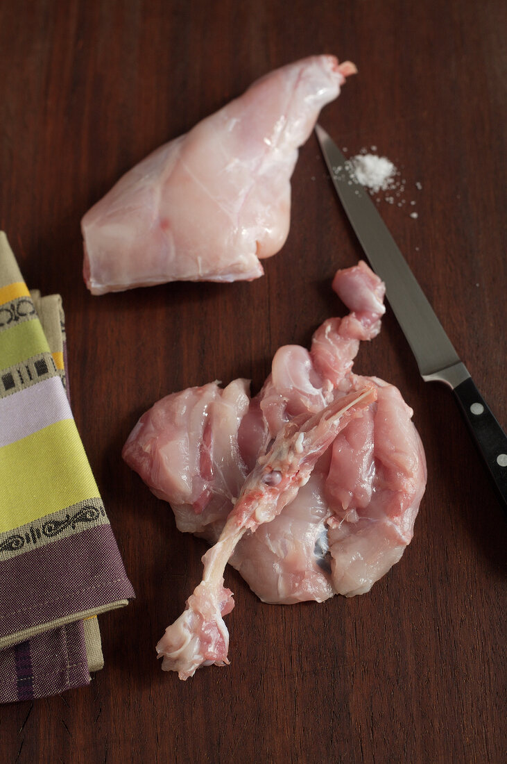 Rabbit leg meat cut with knife, step 1
