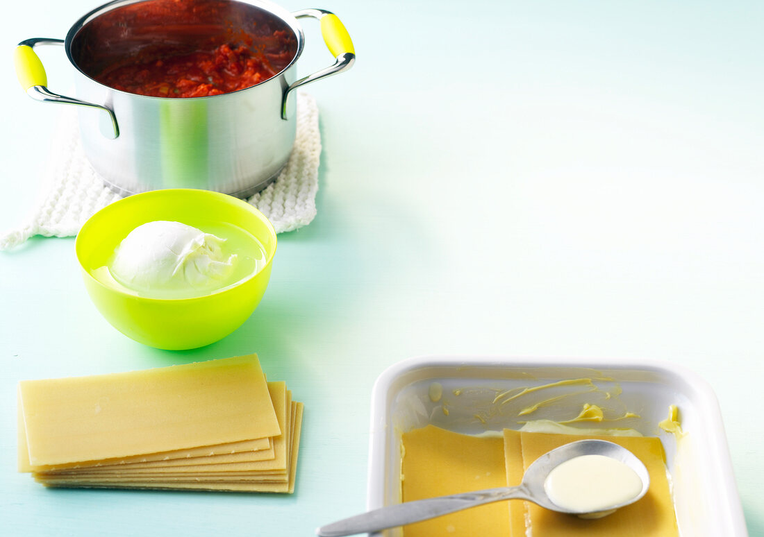 Pasta with mozzarella, pasta plates and tomatoes in pot, ingredients for pasta