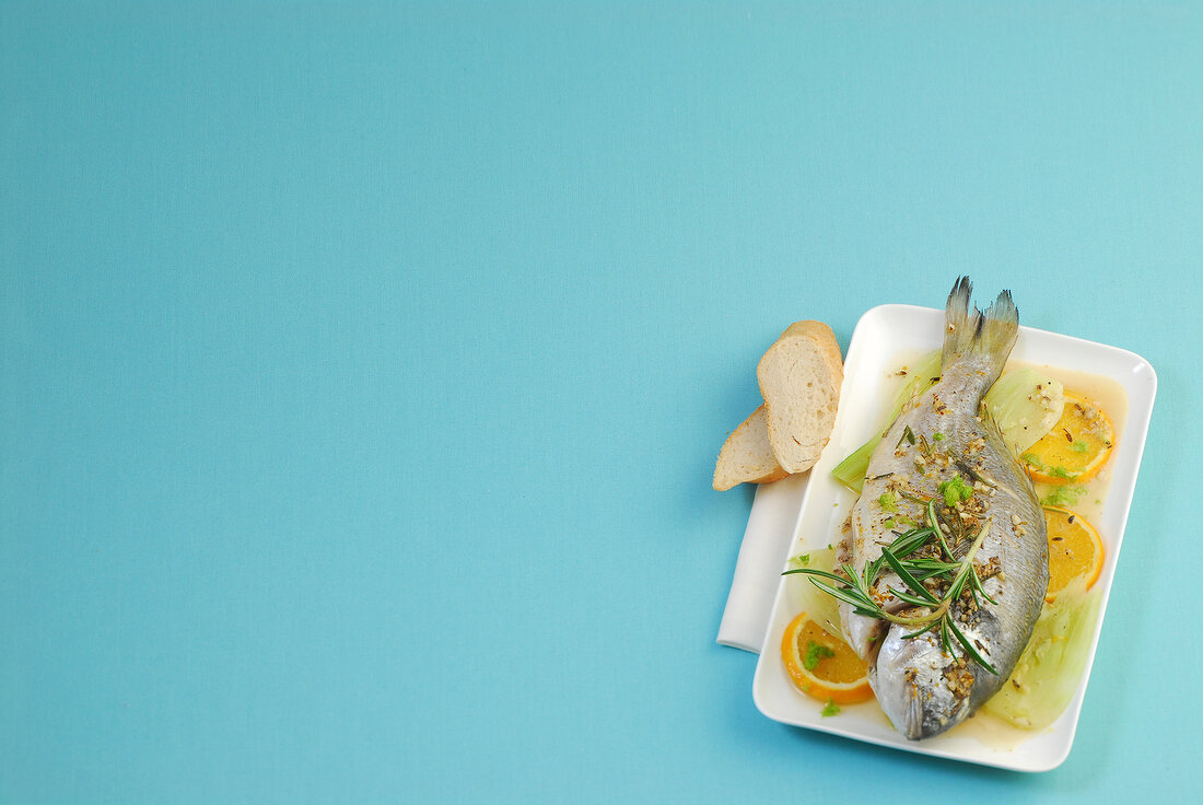 Baked sea bream with fennel on plate