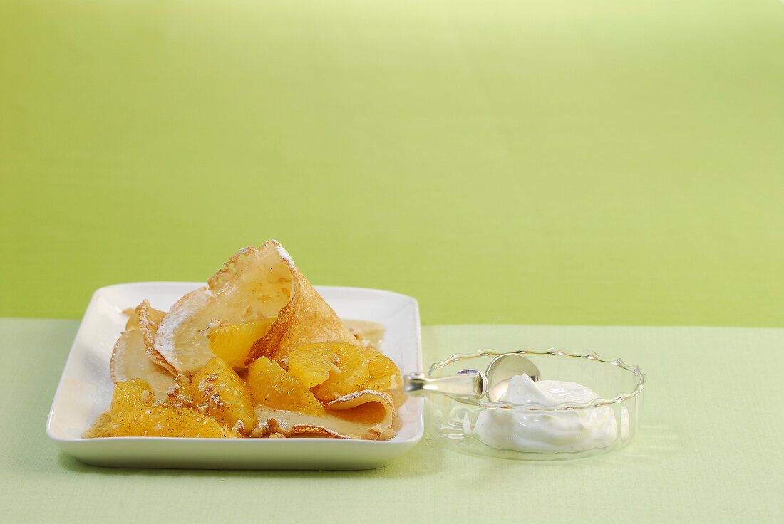 Pancakes with orange salad on plate