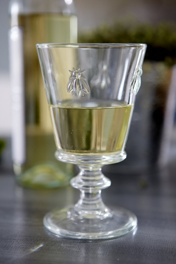 Close-up of wine glass decorated with bees