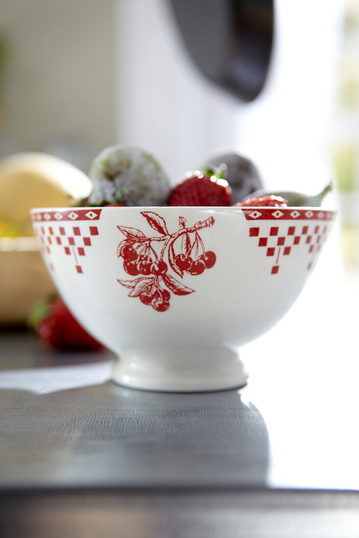 Close-up of ceramic bowl with red cherry print