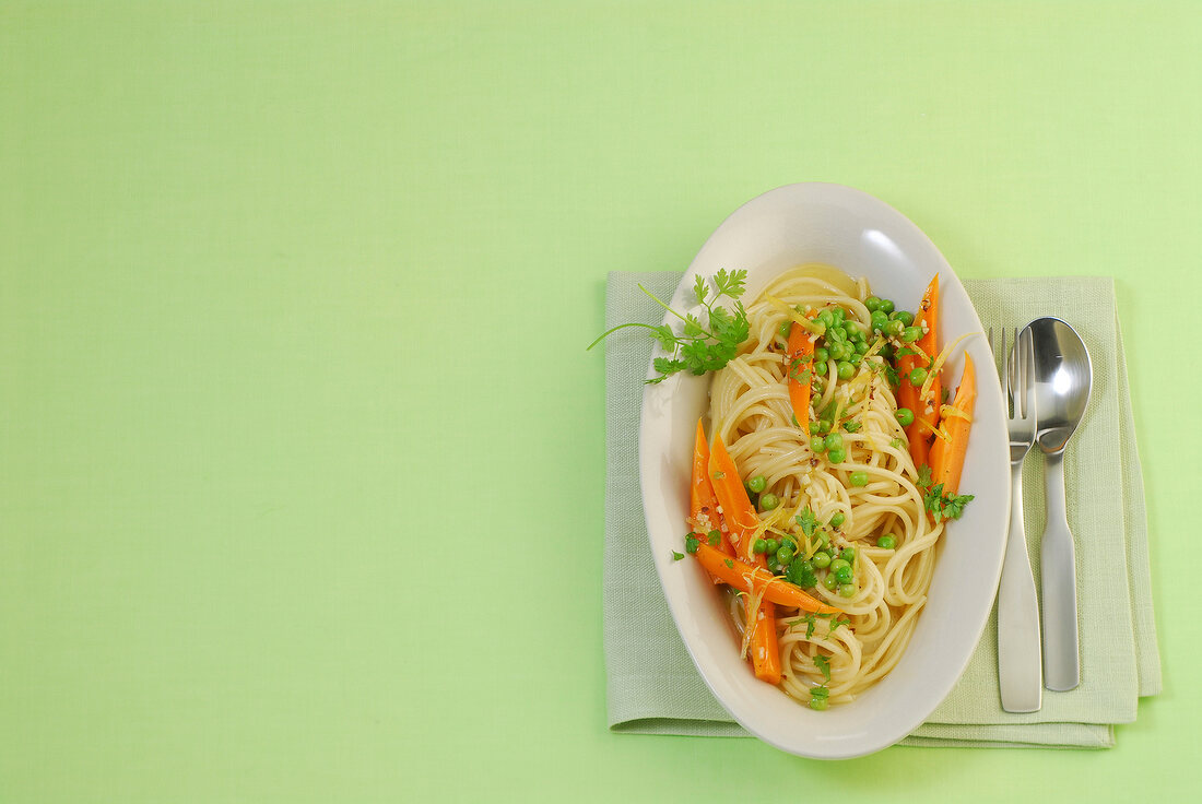 Noodles with carrots and chervil on plate