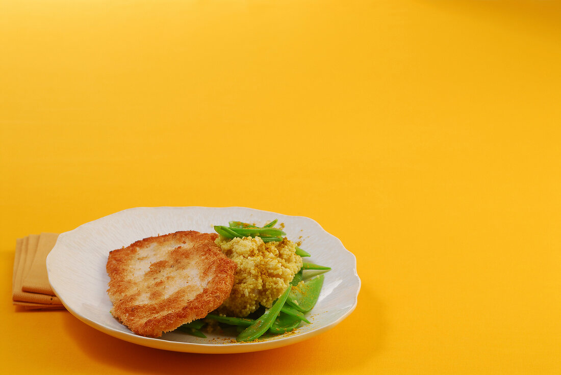 Turkey schnitzel with curried millet on plate