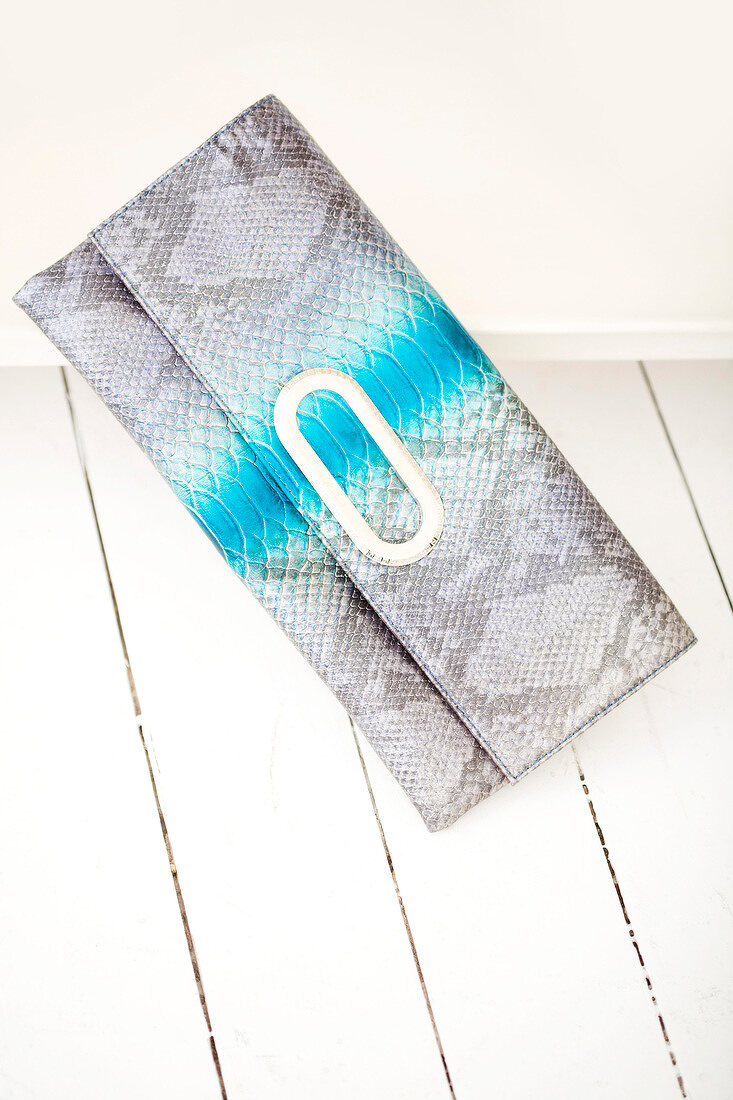 Clutch with reptile print against white background