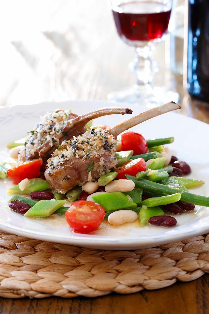 Mixed bean vegetable salad with gratin of lamb chops on plate