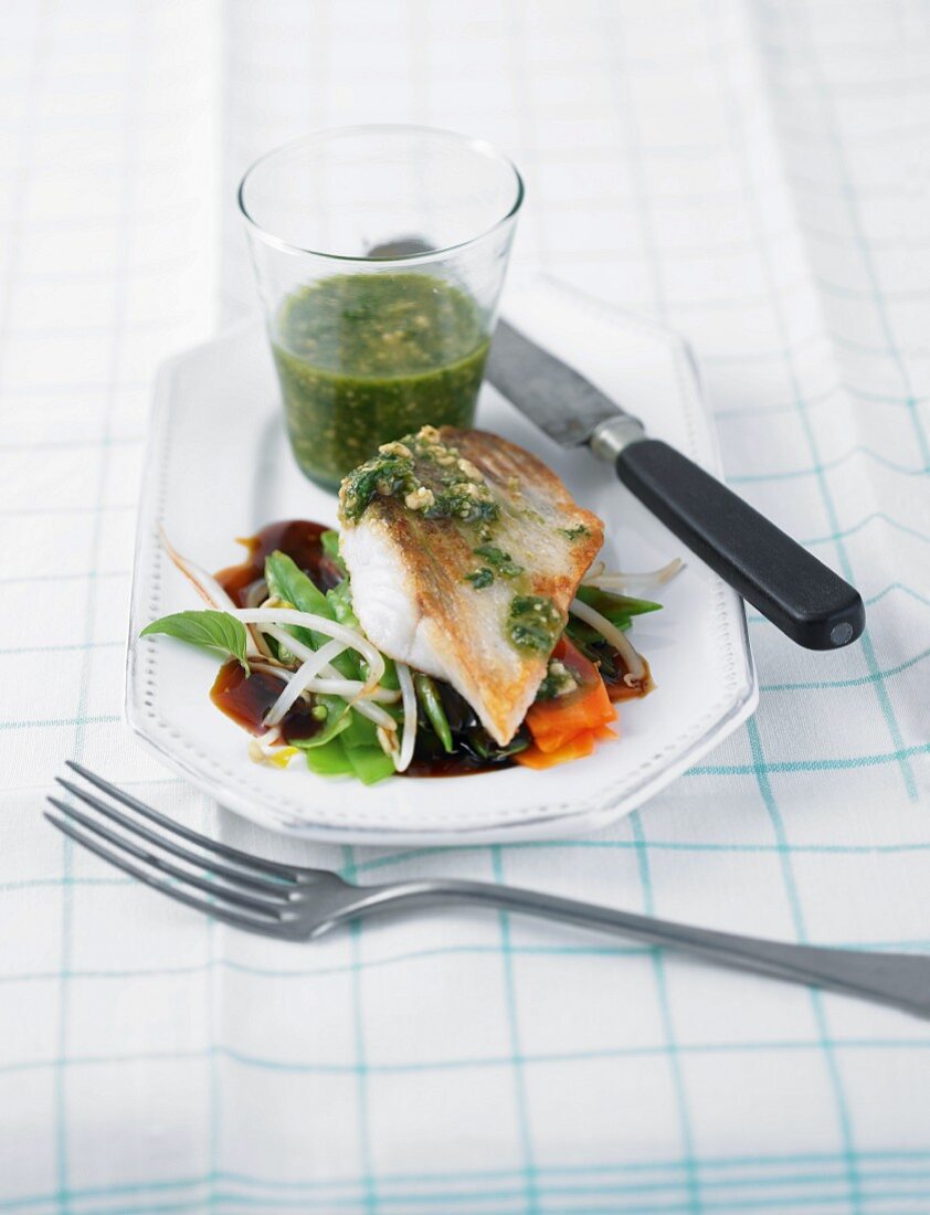 Asian pesto with fried zander and sauce on plate