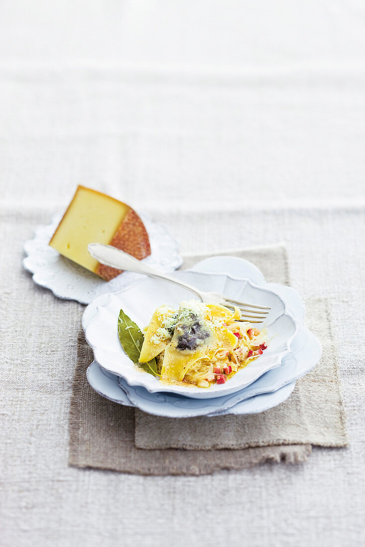 Blood sausage ravioli with yogurt sauerkraut, bacon, cheese and kalmia latifolia in bowl