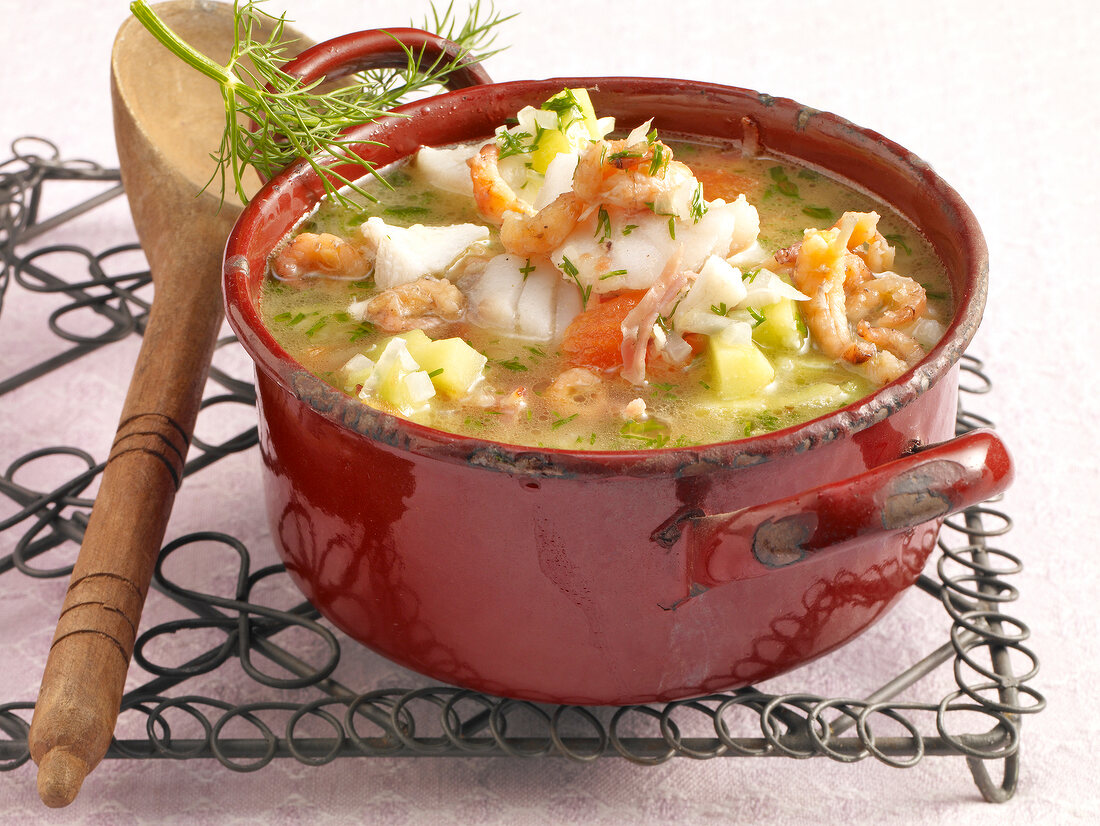 Seafood soup with potatoes, shrimp, dill in casserole