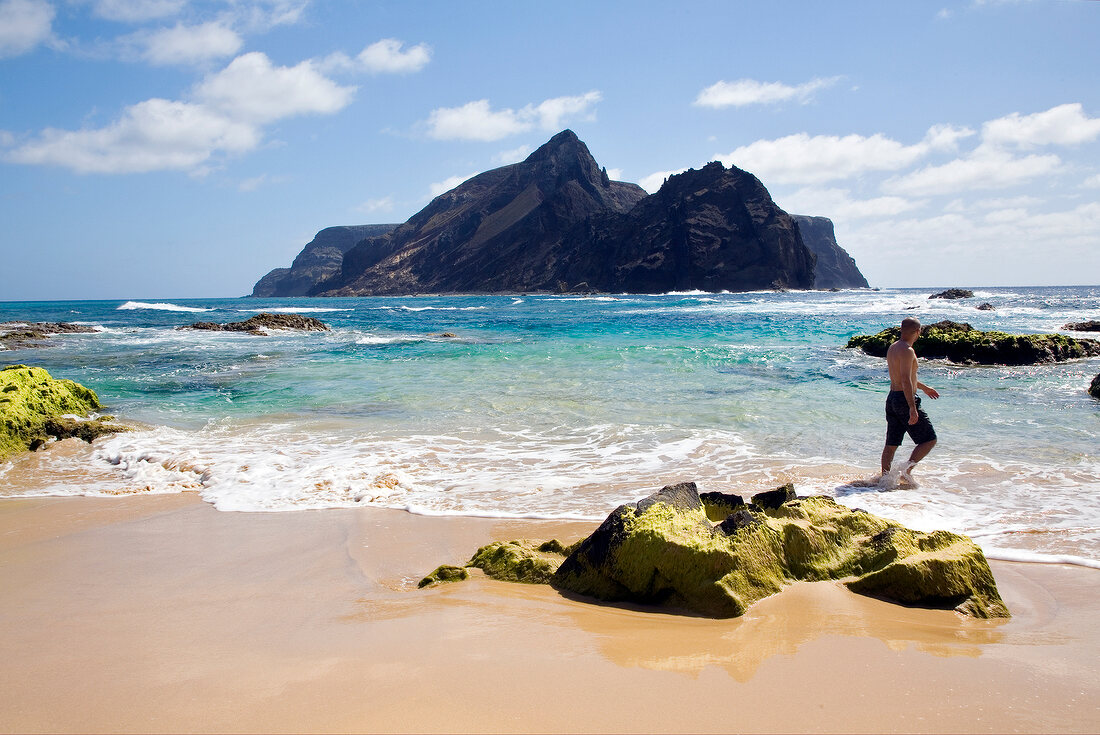 Man walking on beach of Porto Santo island, Madiera, Portugal