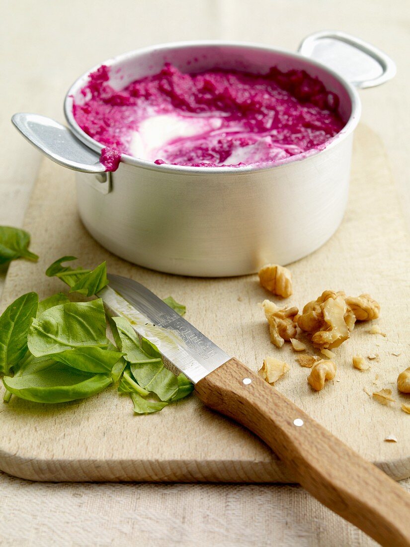 Beetroot sauce with walnuts and basil being made