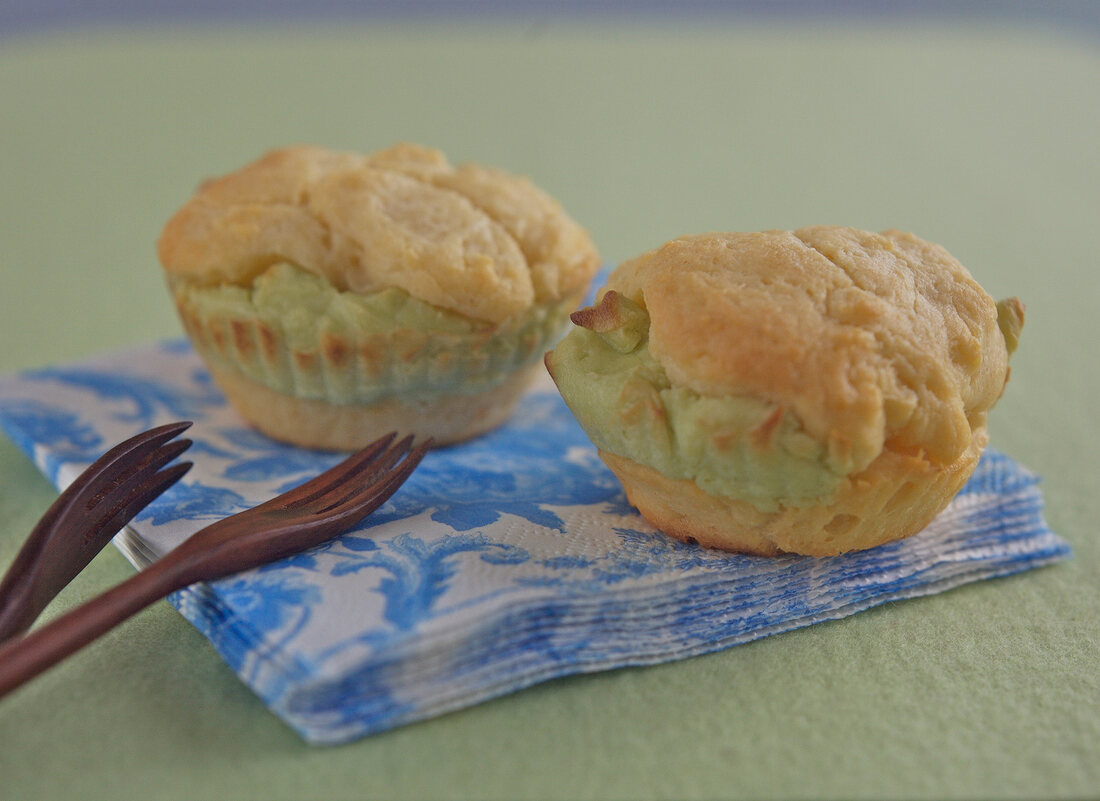 Wasabi cream cheese muffins on paper with small forks