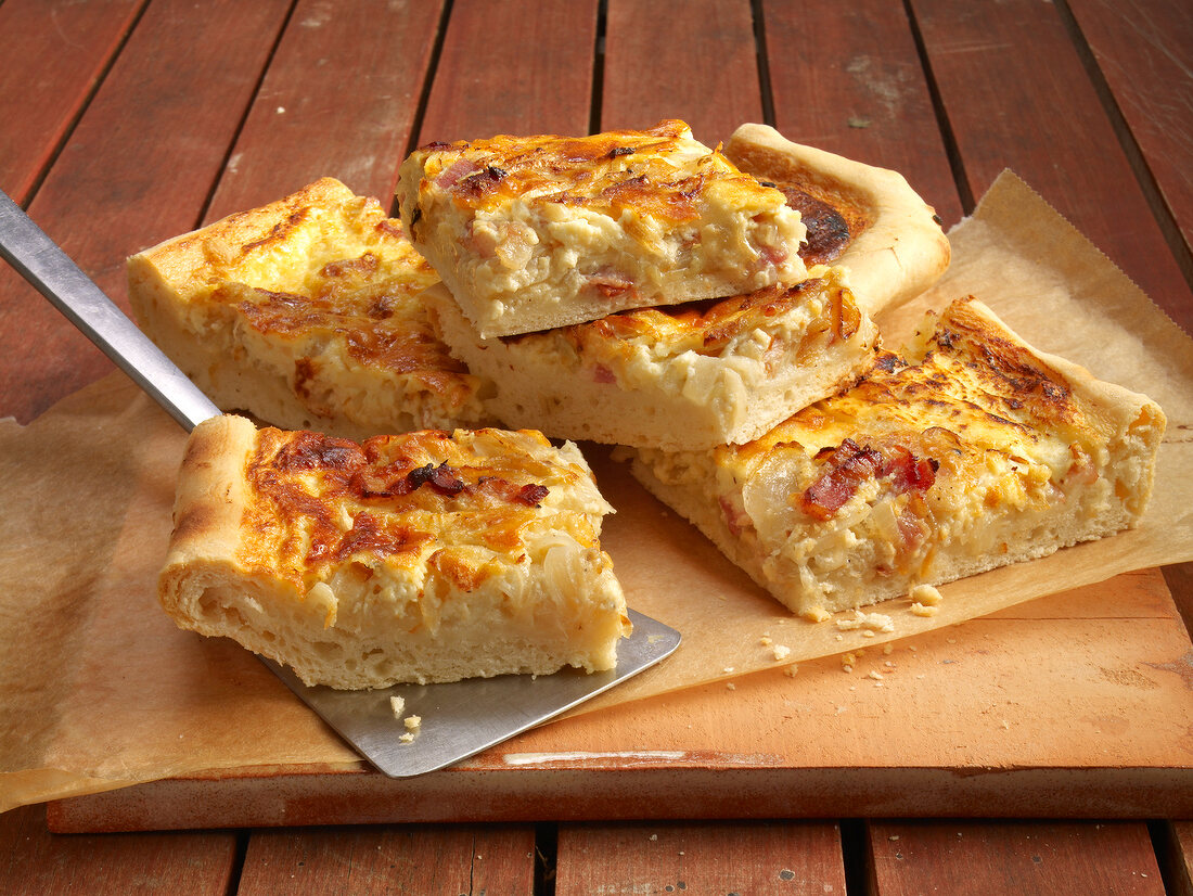 Pieces of palatine flame cake with bacon and onions