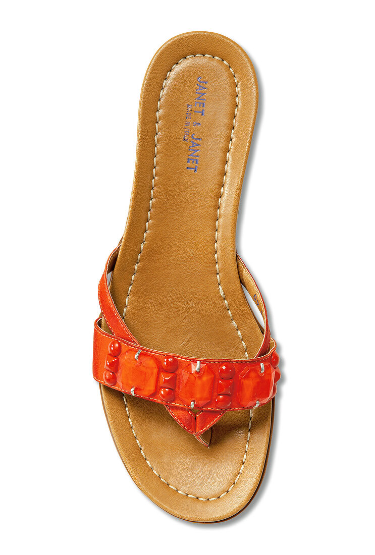 Close-up of orange flip flop on white background