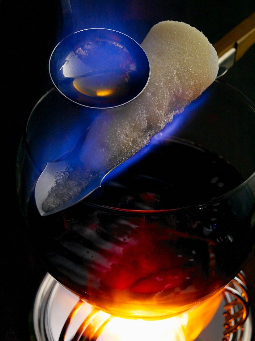 Feuerzangenbowle: rum being poured over a burning sugar cone
