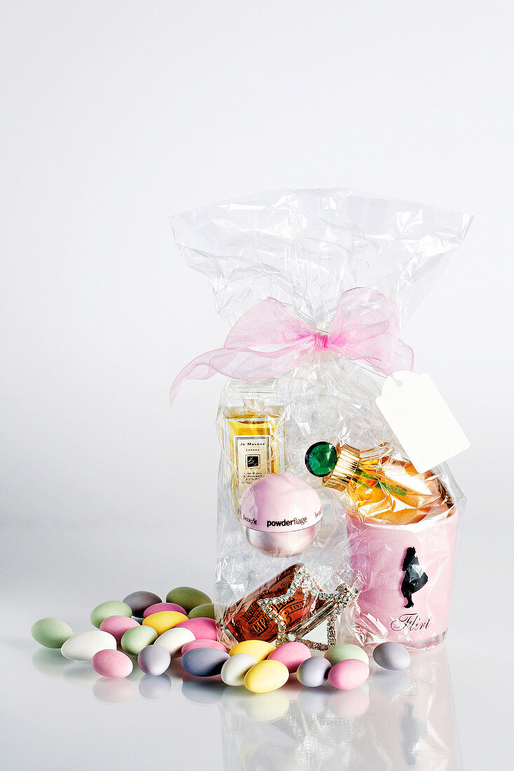 Gift bag with perfume, powder, lip gloss, rhinestone buckle and colourful candies