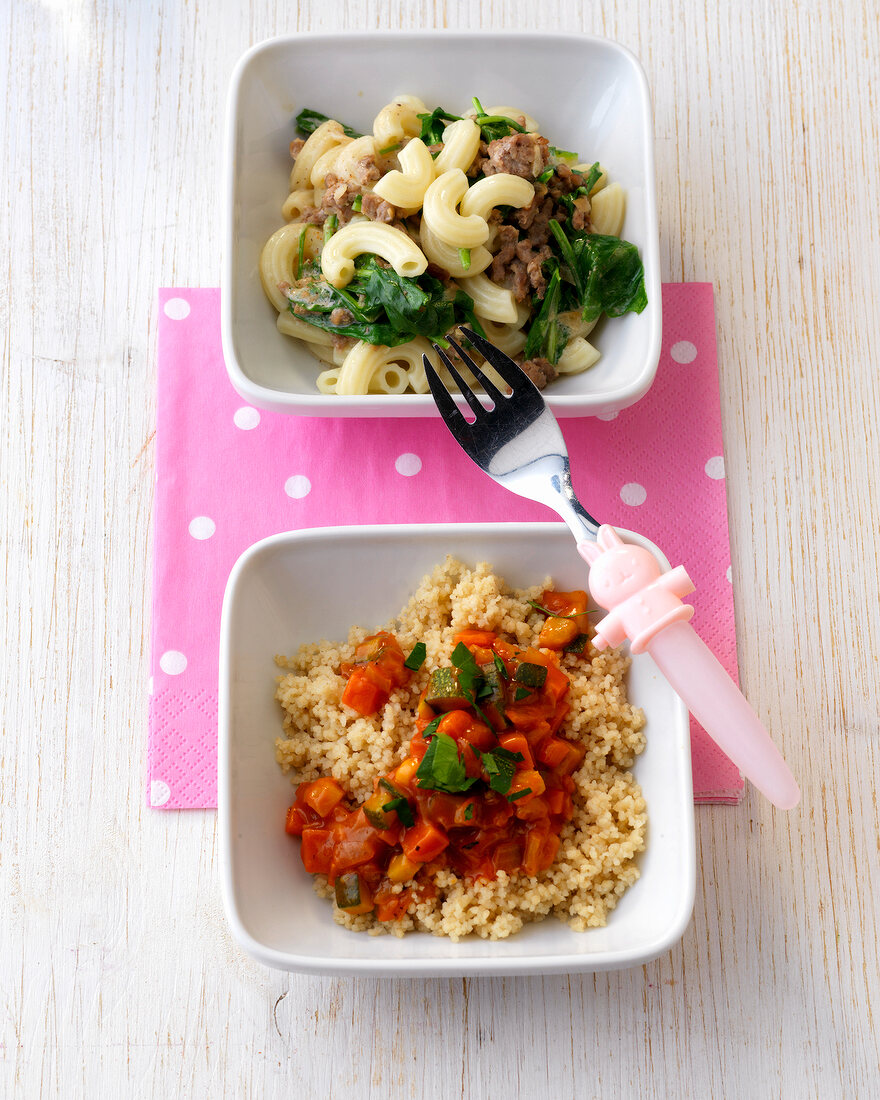 Two bowls of pasta with mince and vegetable stew with couscous