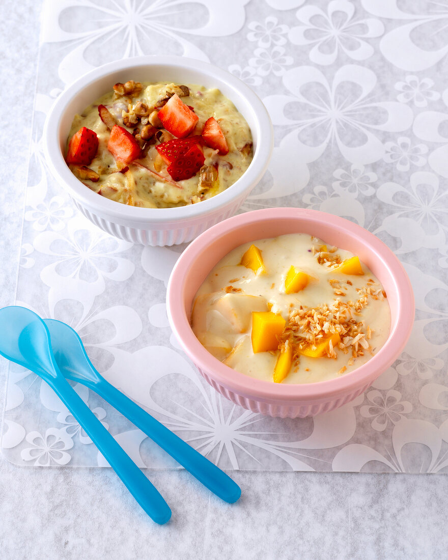 Bowls of strawberries and mangoes with cream