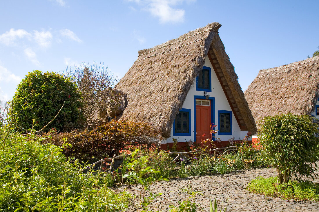 Exterior of house with straw covered roof at Madeira