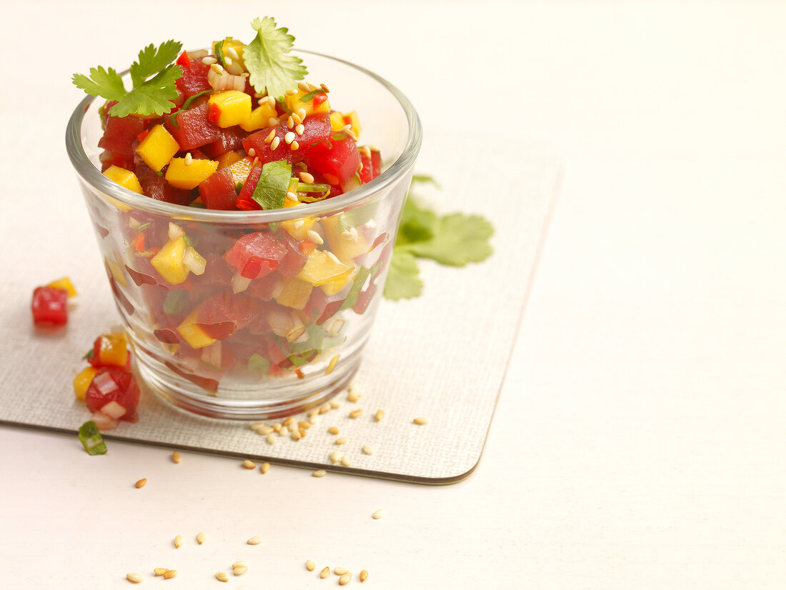 Tuna tartar with mango chili, sesame and coriander in glass