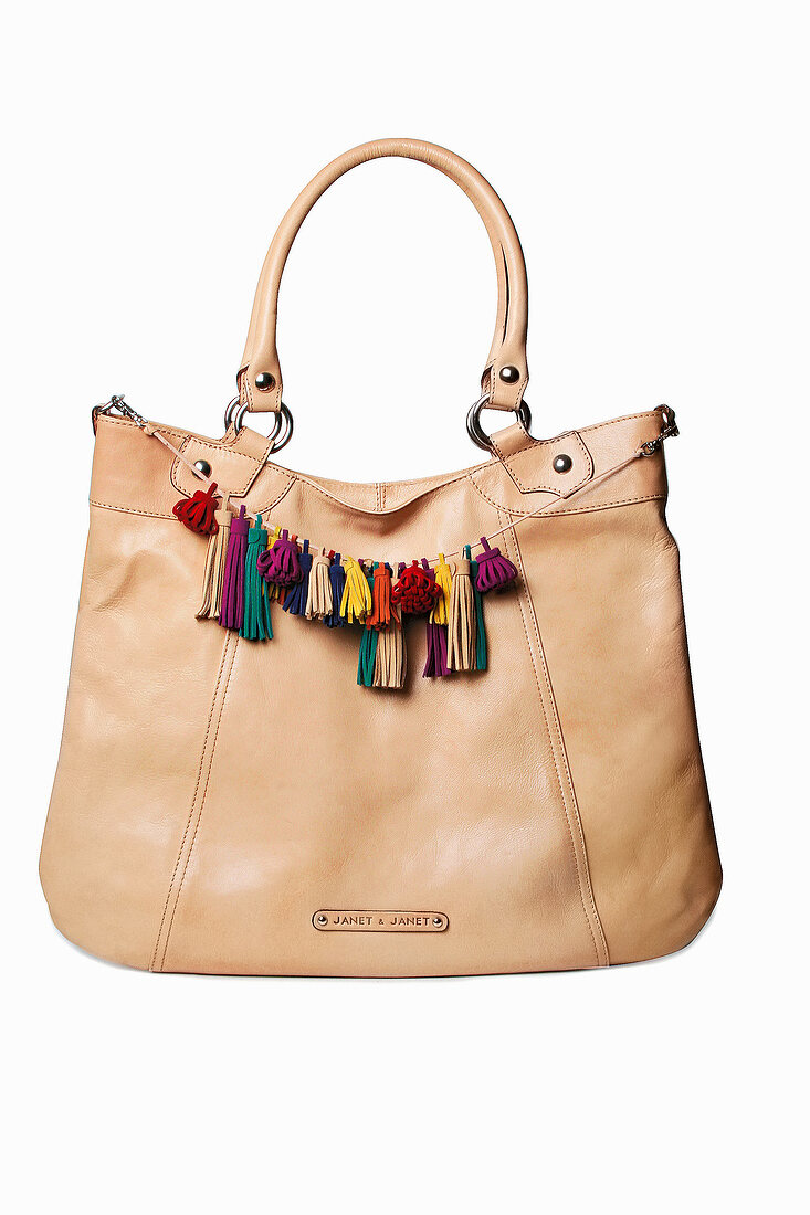 Leather bag with colourful leather fringes against white background