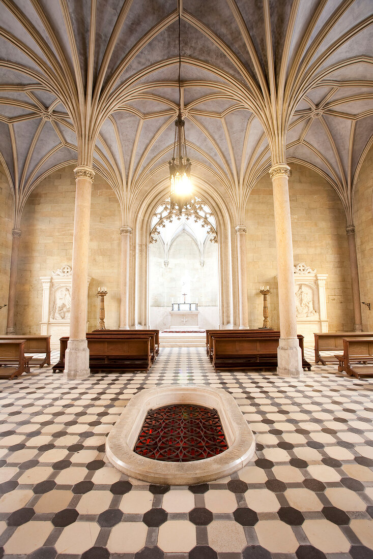 Interiors of The Neogothic chapel with chandelier and benches in Mosovce, Slovakia