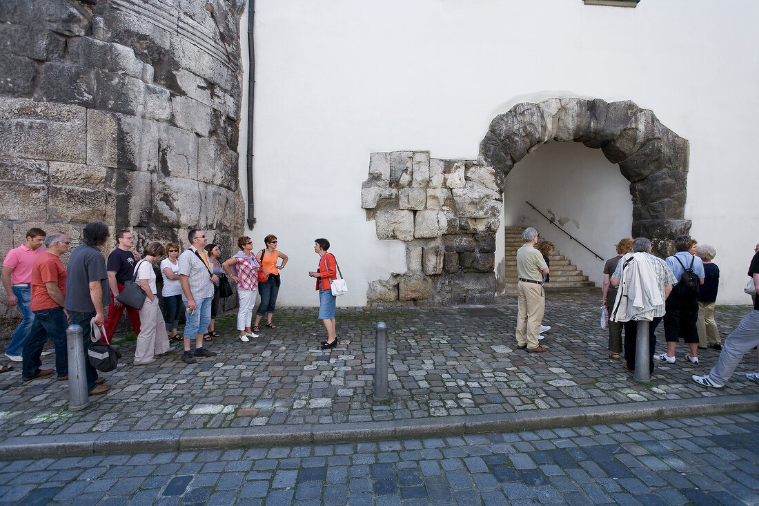 Tourists outside Porta Praetoria in Regensburg, Bavaria, Germany