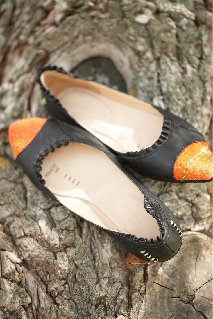 Close-up of black and orange ballerinas shoes