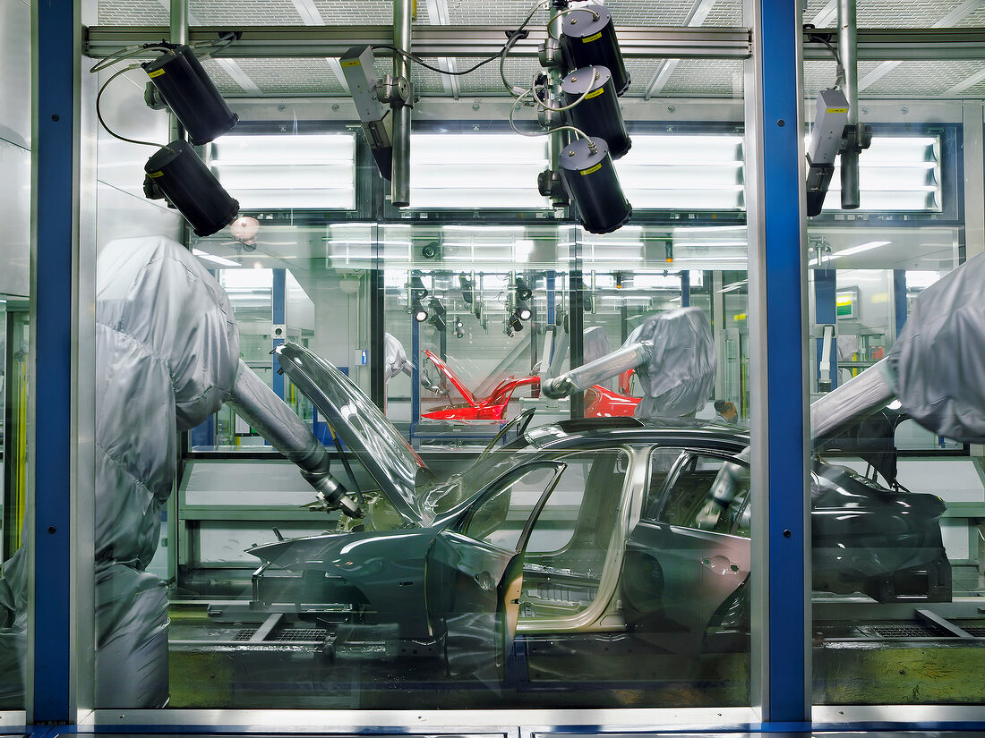 Robots painting a car in production line, BMW World, Munich, Germany