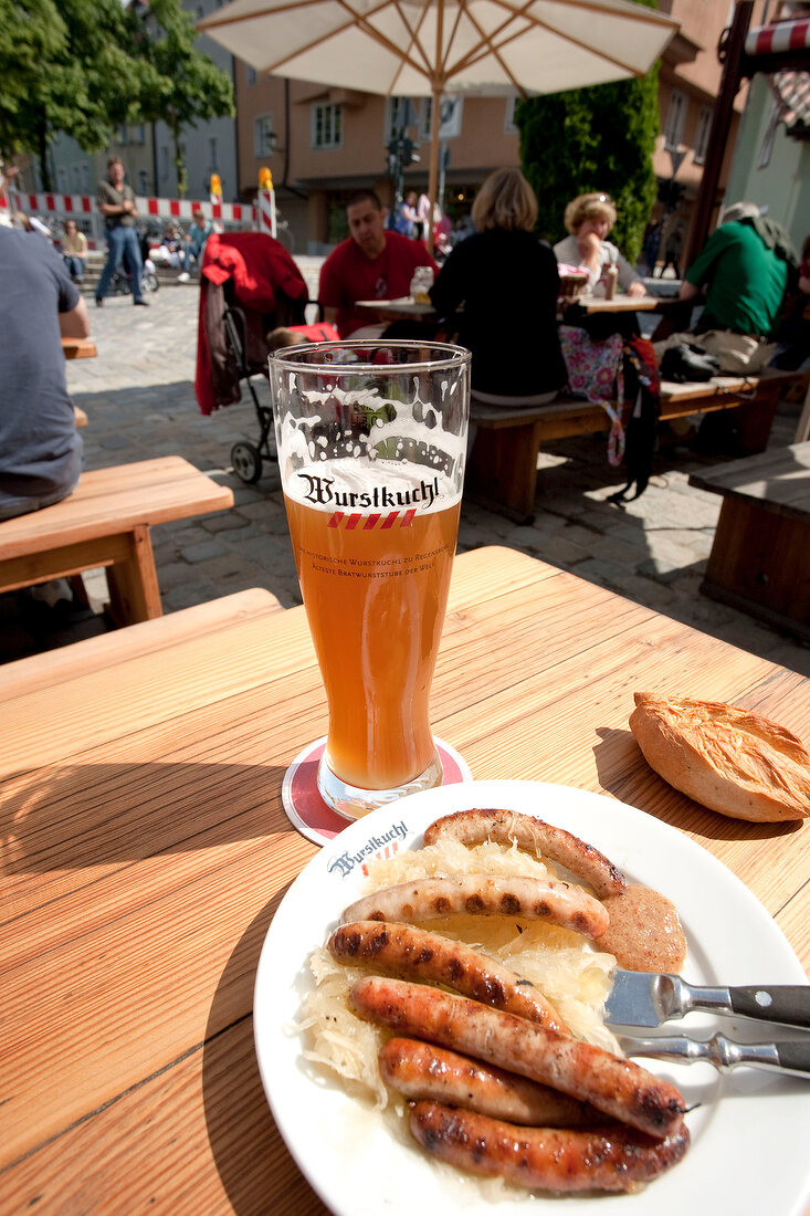 Sausage with bratwurst, sauerkraut and wheat beer on plate, Regensburg
