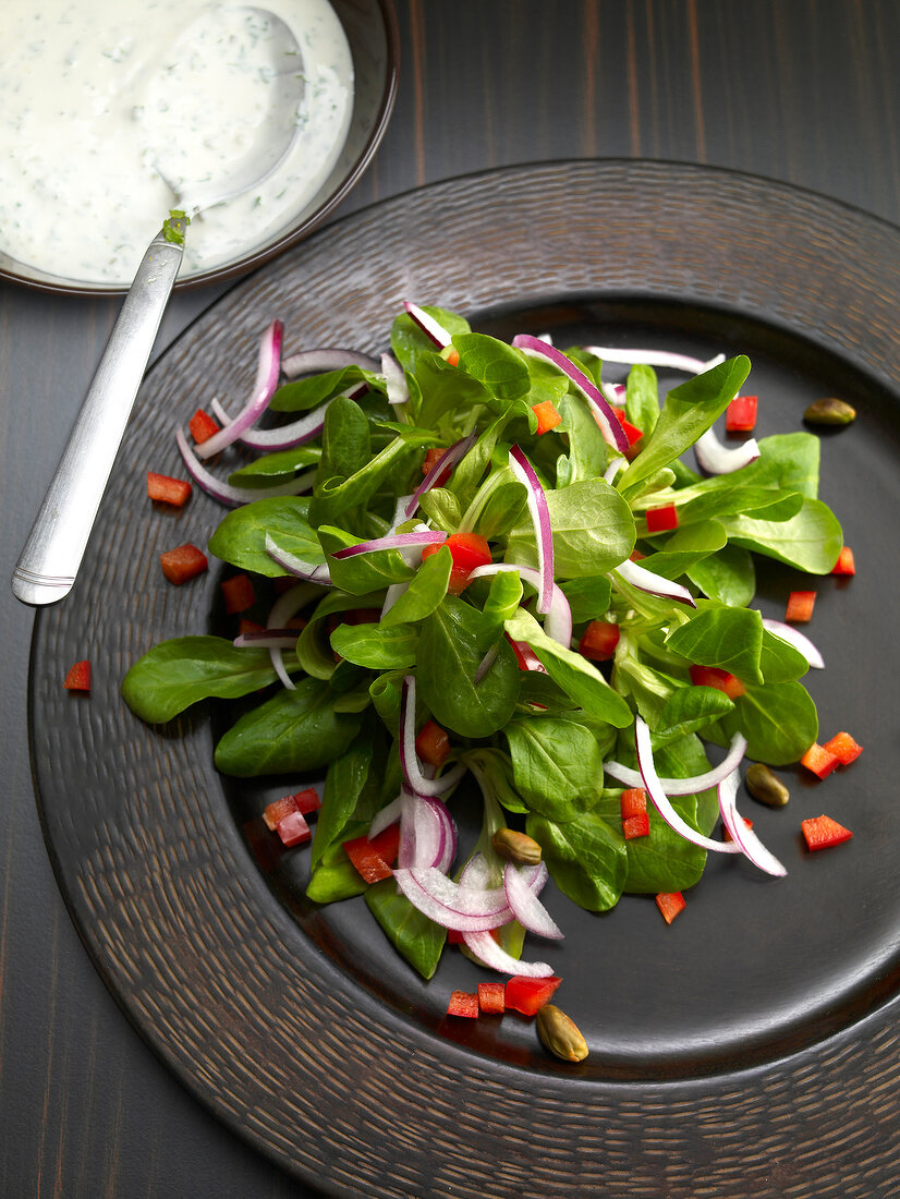 Corn salad with pistachio and goat cheese cream on plate